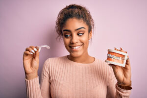 woman deciding between traditional braces and clear aligners