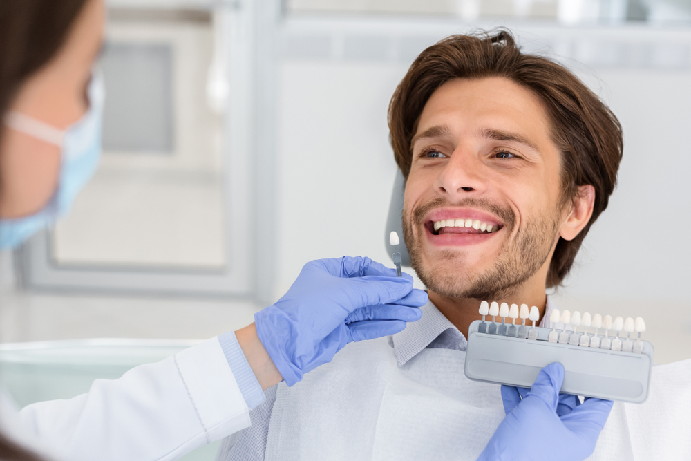 Dentist Checking on Male Patient Teeth Color